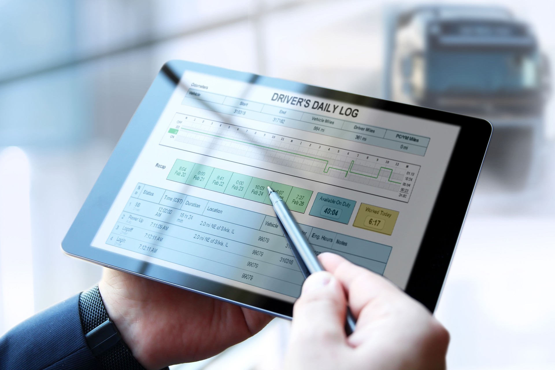 Safety manager is showing to Truck driver the electronic logbooks on a tablet